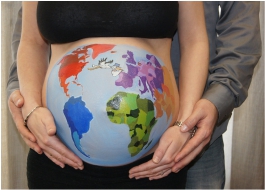 World is painted on a pregnant woman's belly