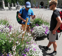 two students carry out field experiments