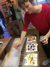 Group members prepare pizzas