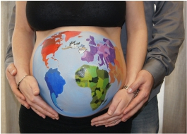 World is painted on a pregnant woman's belly